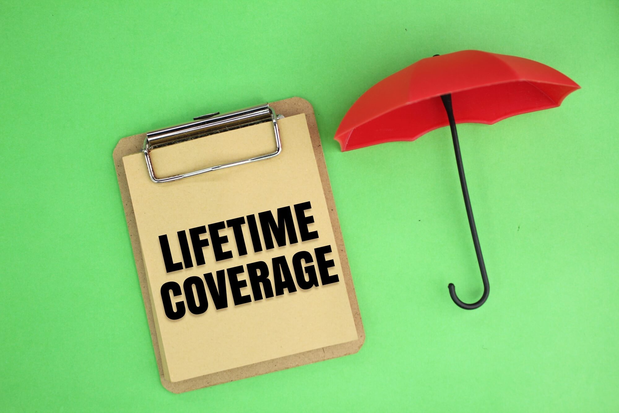 a small umbrella and bookboard with the words Lifetime Coverage.